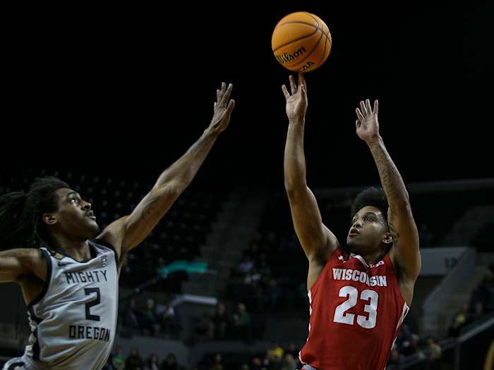 Wisconsin guard Chucky Hepburn puts up a shot under coverage from Oregon guard Tyrone Williams as the Oregon Ducks host Wisconsin in the quarterfinal round of the NIT Tuesday, March 21, 2023 at Matthew Knight Arena in Eugene, Ore. Ncaa Basketball Wisconsin At Oregon Mbb Nit Wisconsin At Oregon